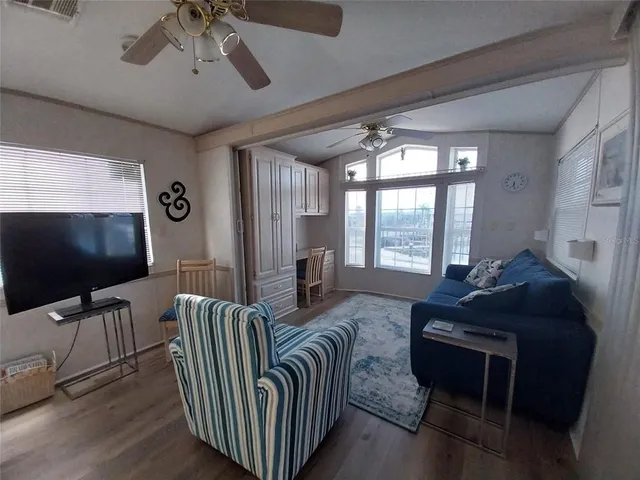a kitchen with white cabinets and sink
