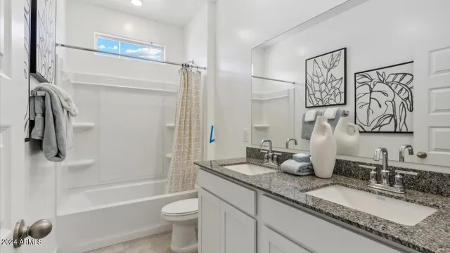 a bathroom with a granite countertop sink mirror toilet and bathtub