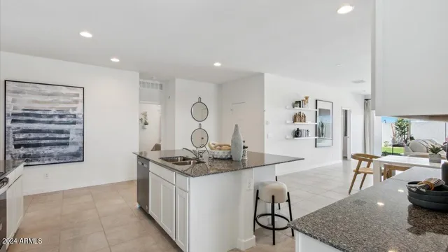a kitchen with stainless steel appliances granite countertop a stove and a sink