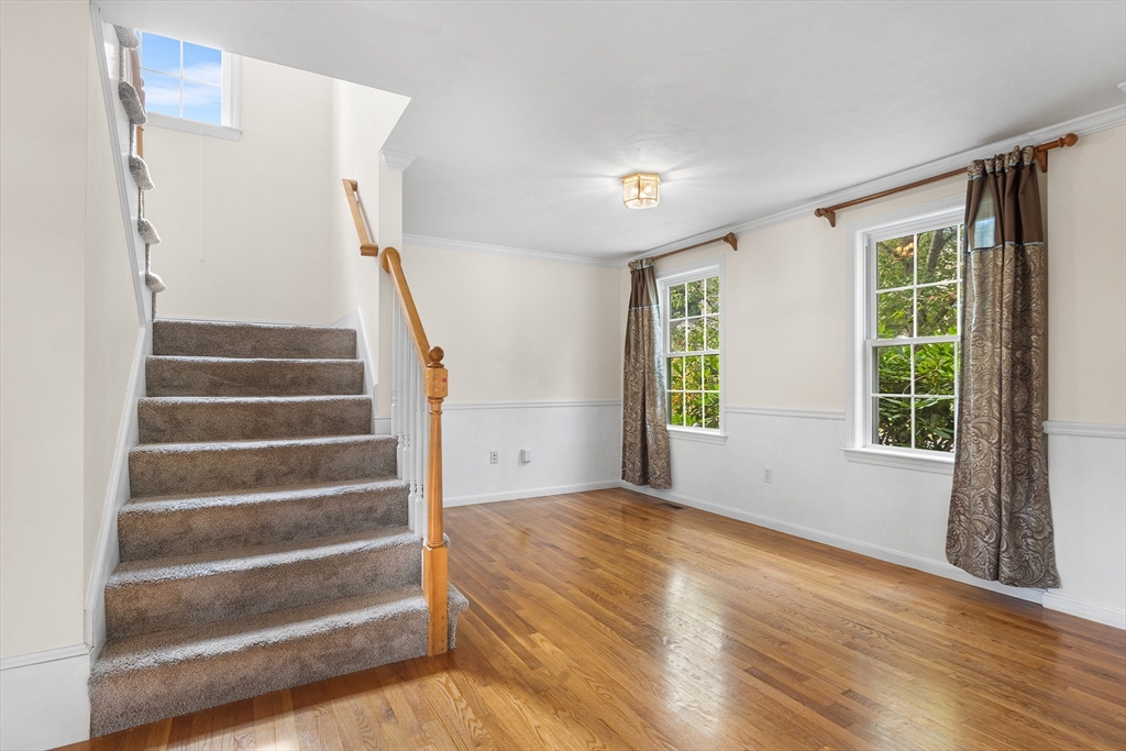 70 Loring Avenue Boxborough, MA 01719 - Photo 12 of 33 a view of an empty room with wooden floor and windows