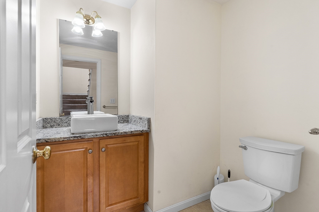 70 Loring Avenue Boxborough, MA 01719 - Photo 13 of 33 a bathroom with a granite countertop toilet and a sink