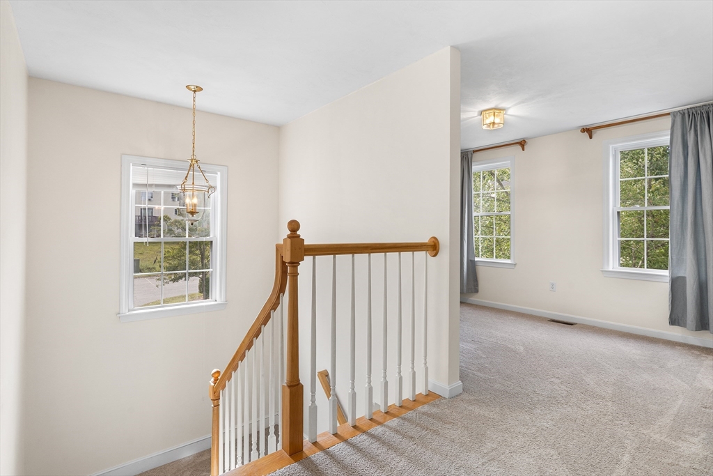 70 Loring Avenue Boxborough, MA 01719 - Photo 14 of 33 a view of a hallway with windows