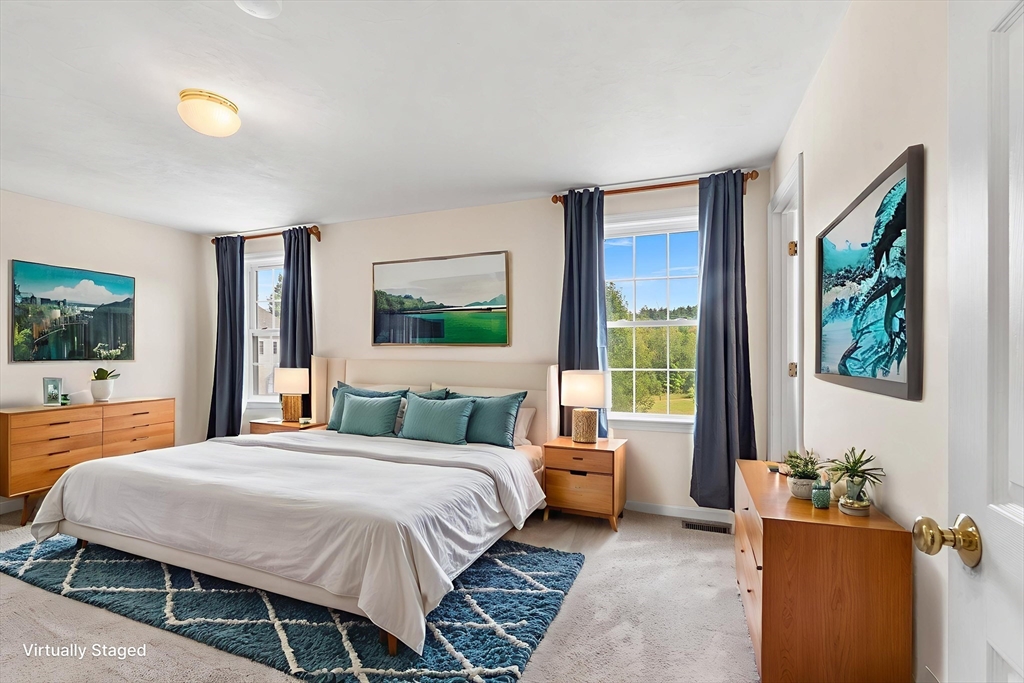 70 Loring Avenue Boxborough, MA 01719 - Photo 16 of 33 a bedroom with a bed and a flat screen tv