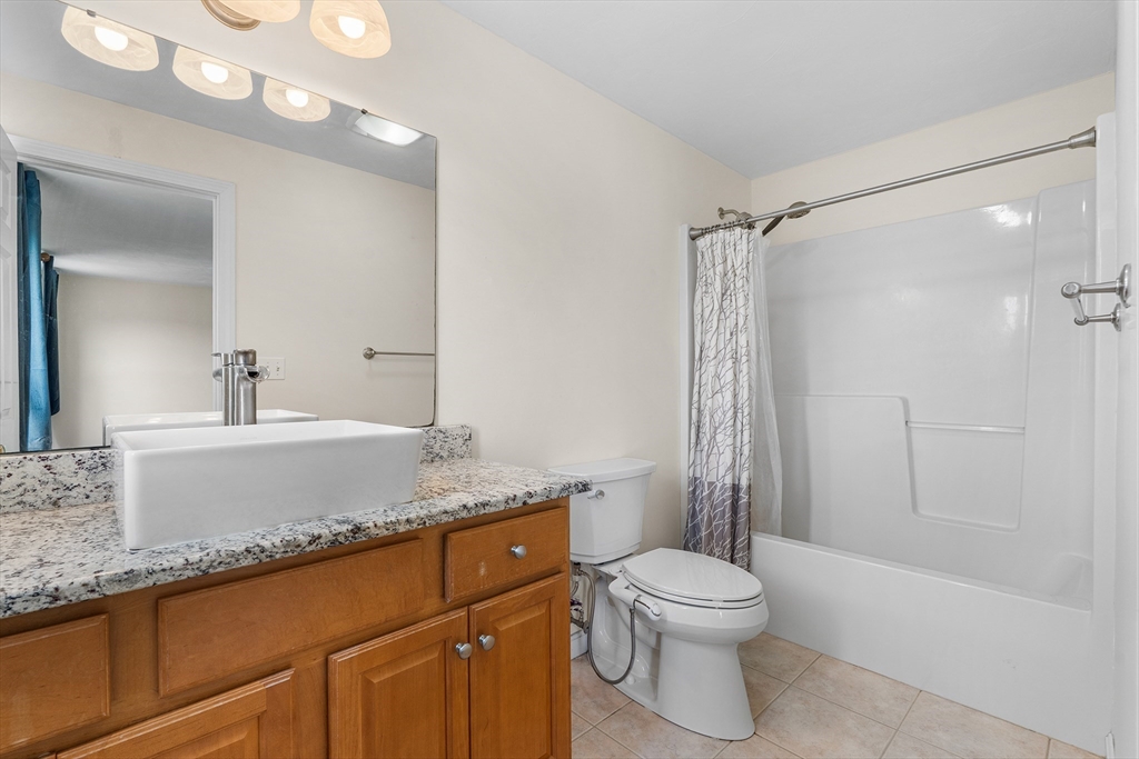 70 Loring Avenue Boxborough, MA 01719 - Photo 18 of 33 a bathroom with a granite countertop sink toilet a shower and a mirror