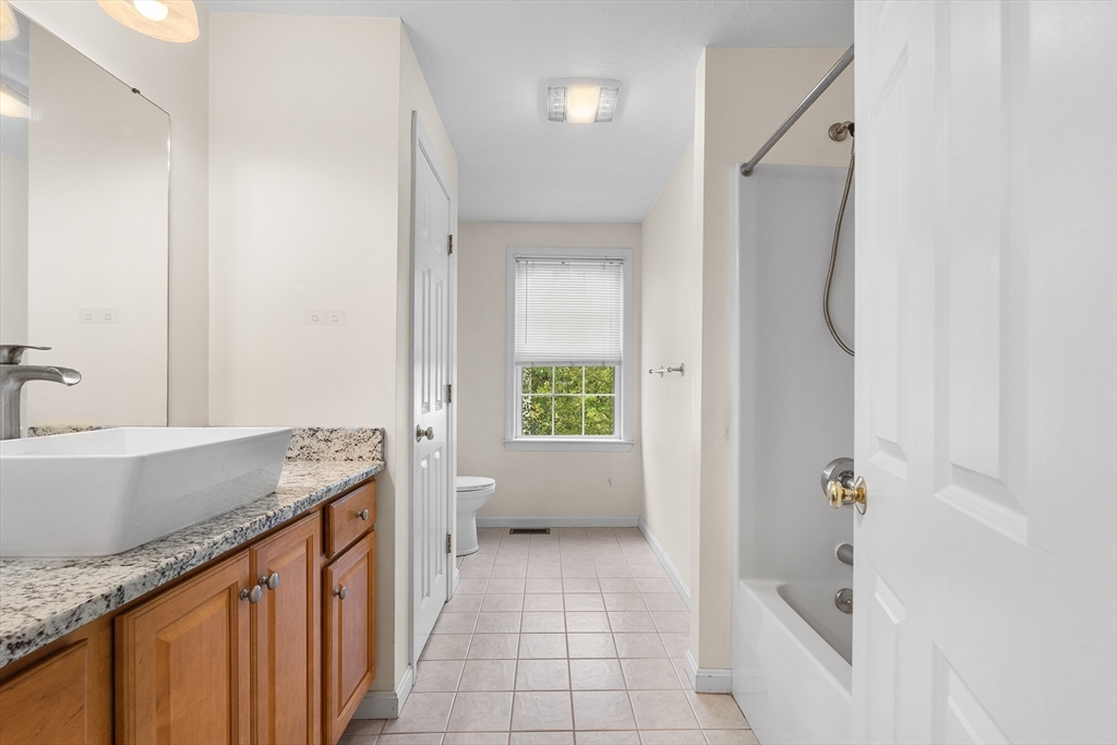 70 Loring Avenue Boxborough, MA 01719 - Photo 23 of 33 a bathroom with a granite countertop sink a toilet and shower