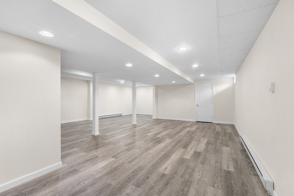 70 Loring Avenue Boxborough, MA 01719 - Photo 25 of 33 an empty room with wooden floor and windows