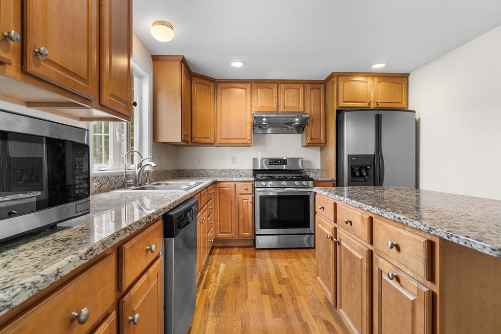 70 Loring Avenue Boxborough, MA 01719 - Photo 3 of 33 a kitchen with stainless steel appliances granite countertop a stove a sink and a microwave
