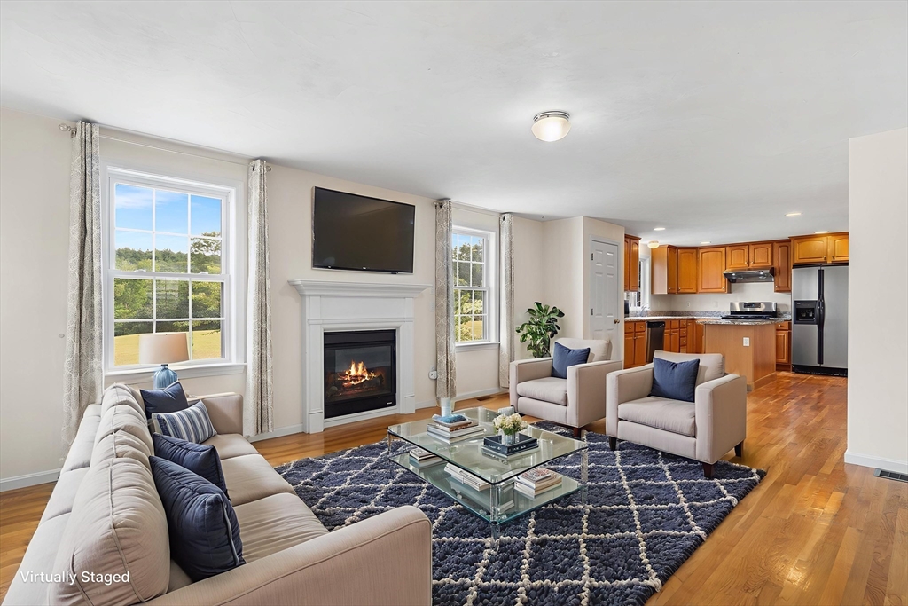 70 Loring Avenue Boxborough, MA 01719 - Photo 7 of 33 a living room with furniture fireplace and a table