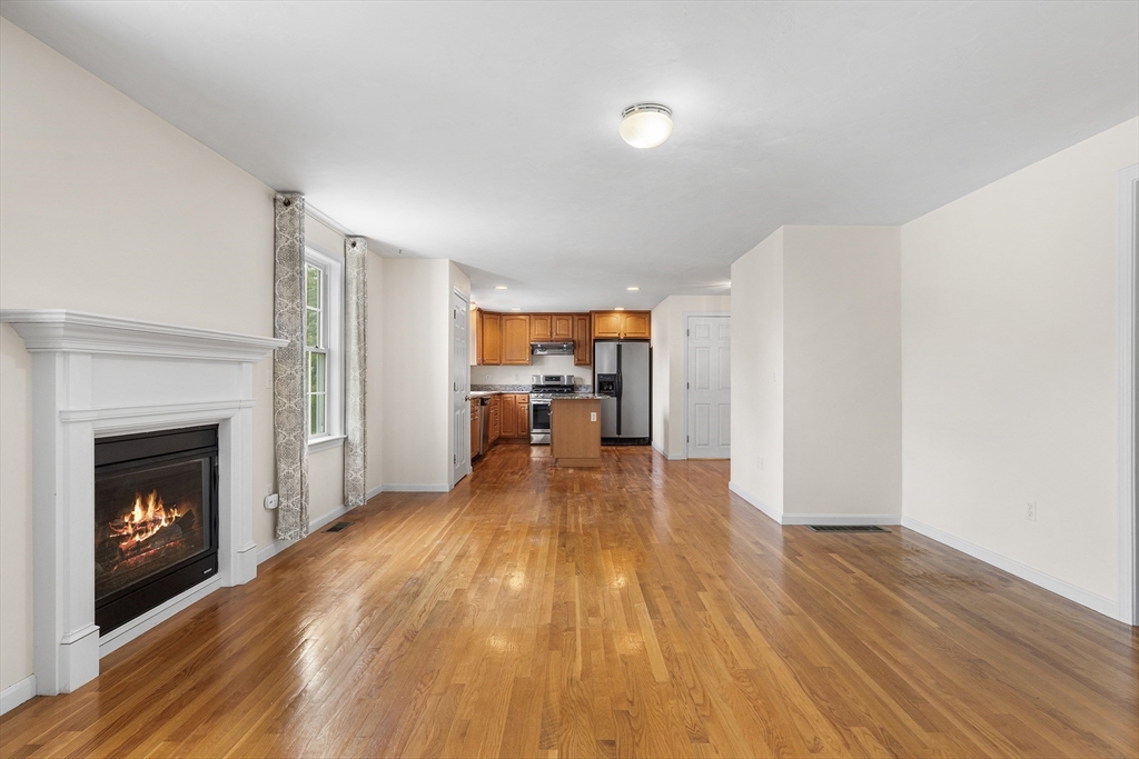 70 Loring Avenue Boxborough, MA 01719 - Photo 8 of 33 a view of a room with wooden floor fireplace and window