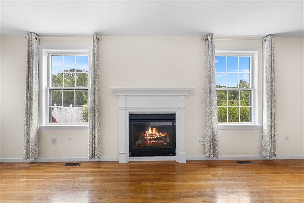 70 Loring Avenue Boxborough, MA 01719 - Photo 9 of 33 a living room with a fireplace and a window