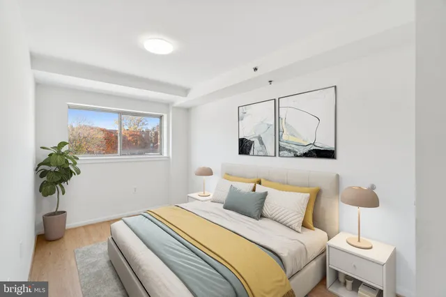 a bedroom with a bed and a potted plant