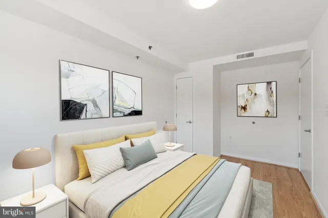 a bedroom with a bed and a painting on the wall