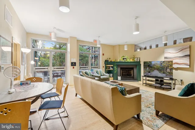a living room with fireplace furniture and a large window