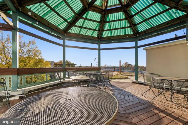 a view of a balcony with a table and chairs