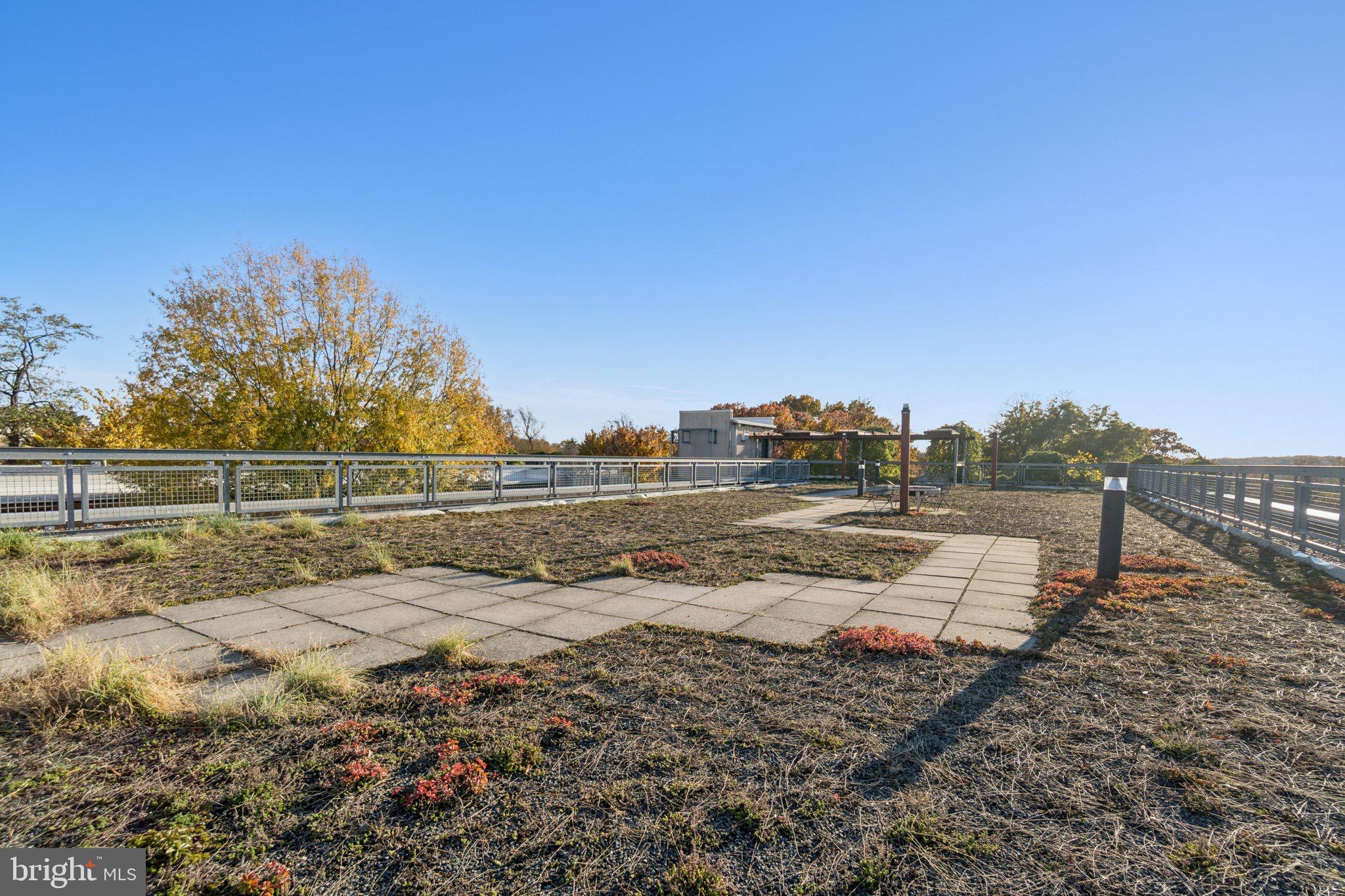 7981 Eastern Avenue Northwest, Unit 204 Silver Spring, MD 20910 - Photo 32 of 32 Spacious outdoor rooftop with walkway&solar panels