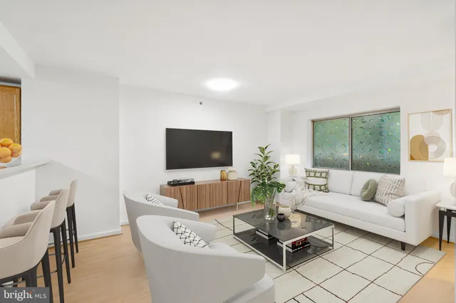 a living room with furniture a flat screen tv and a large window