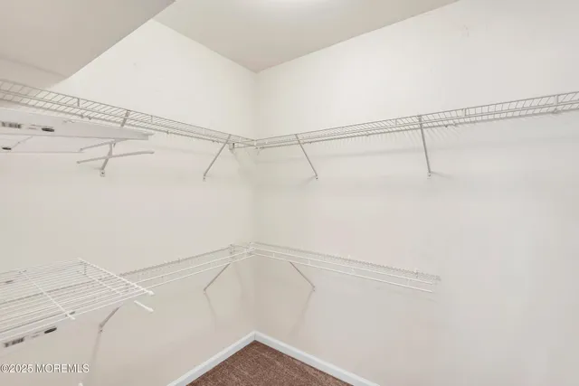 a living room with a couch and a dresser with wooden floor