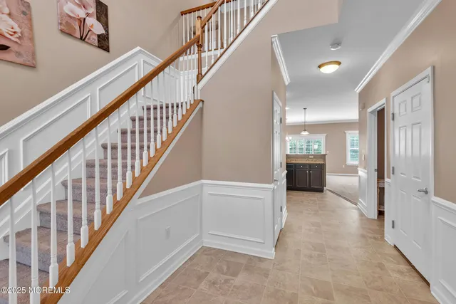 a view of entryway and hall with wooden floor