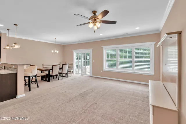 a living room with lots of furniture and a large window