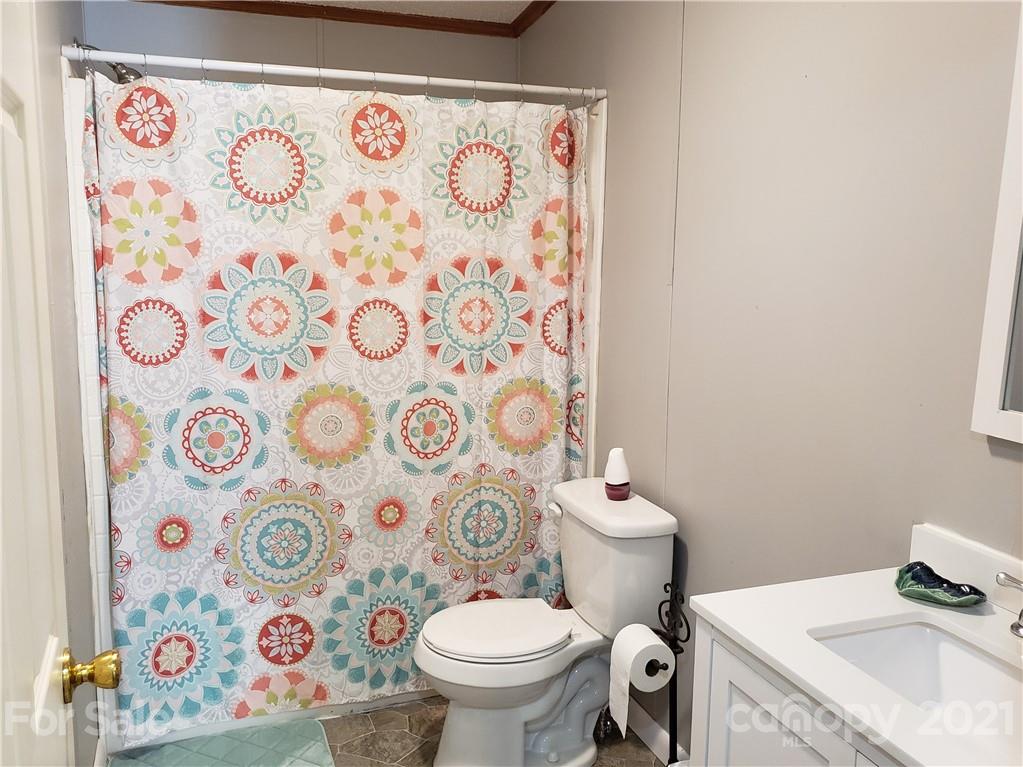 2012 State Rd S-46-168 York, SC 29745 - Photo 24 of 48 a white toilet sitting next to a shower curtain