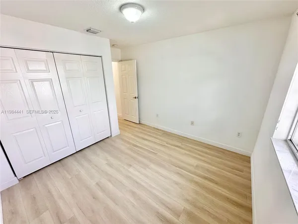 a bathroom with a sink a toilet and a large mirror