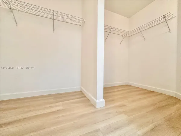 a view of walk in closet with empty racks