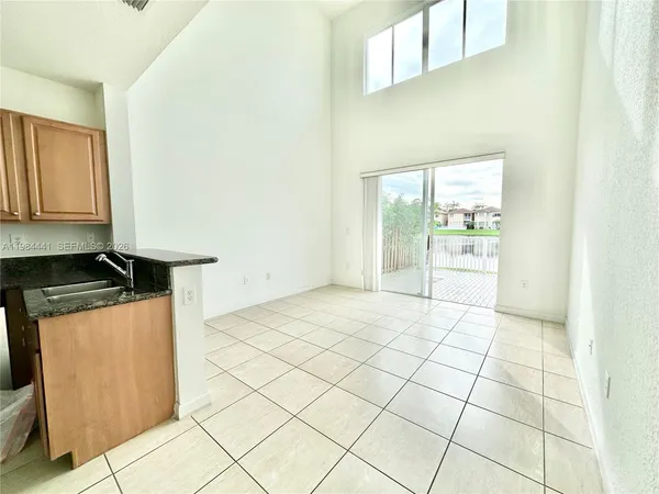 a kitchen with granite countertop a stove a sink and a microwave