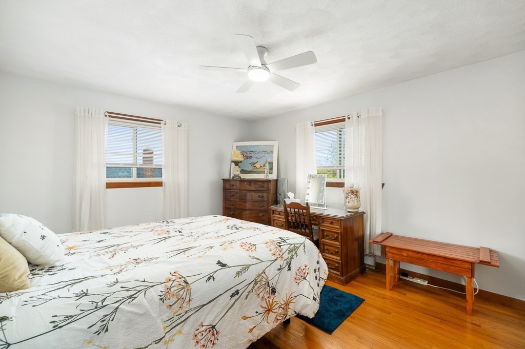 9 Alpine Court Gloucester, MA 01930 - Photo 22 of 32 a bedroom with a bed and a dresser with wooden floor