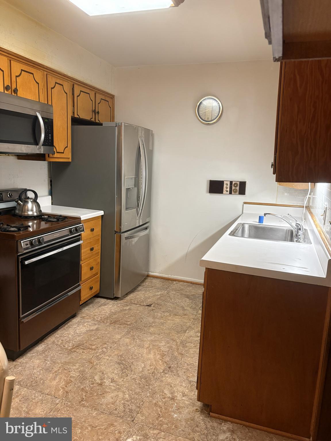 4523 Kinmount Road Lanham, MD 20706 - Photo 16 of 38 a kitchen with a sink appliances and cabinets