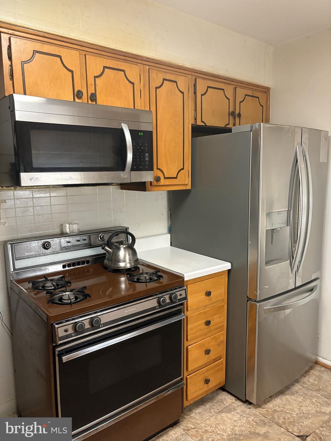 4523 Kinmount Road Lanham, MD 20706 - Photo 19 of 38 a kitchen with stainless steel appliances granite countertop a stove and a microwave