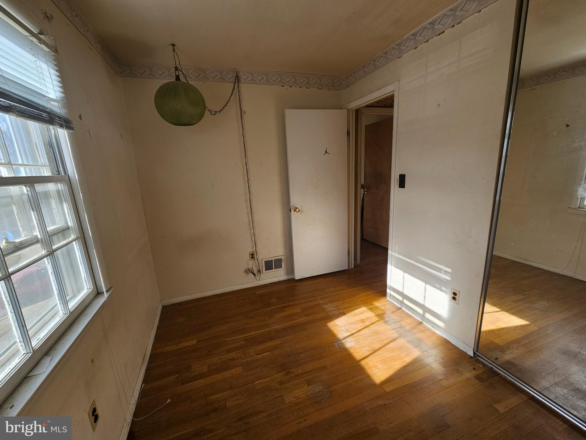4523 Kinmount Road Lanham, MD 20706 - Photo 21 of 38 a view of an empty room with a window and wooden floor