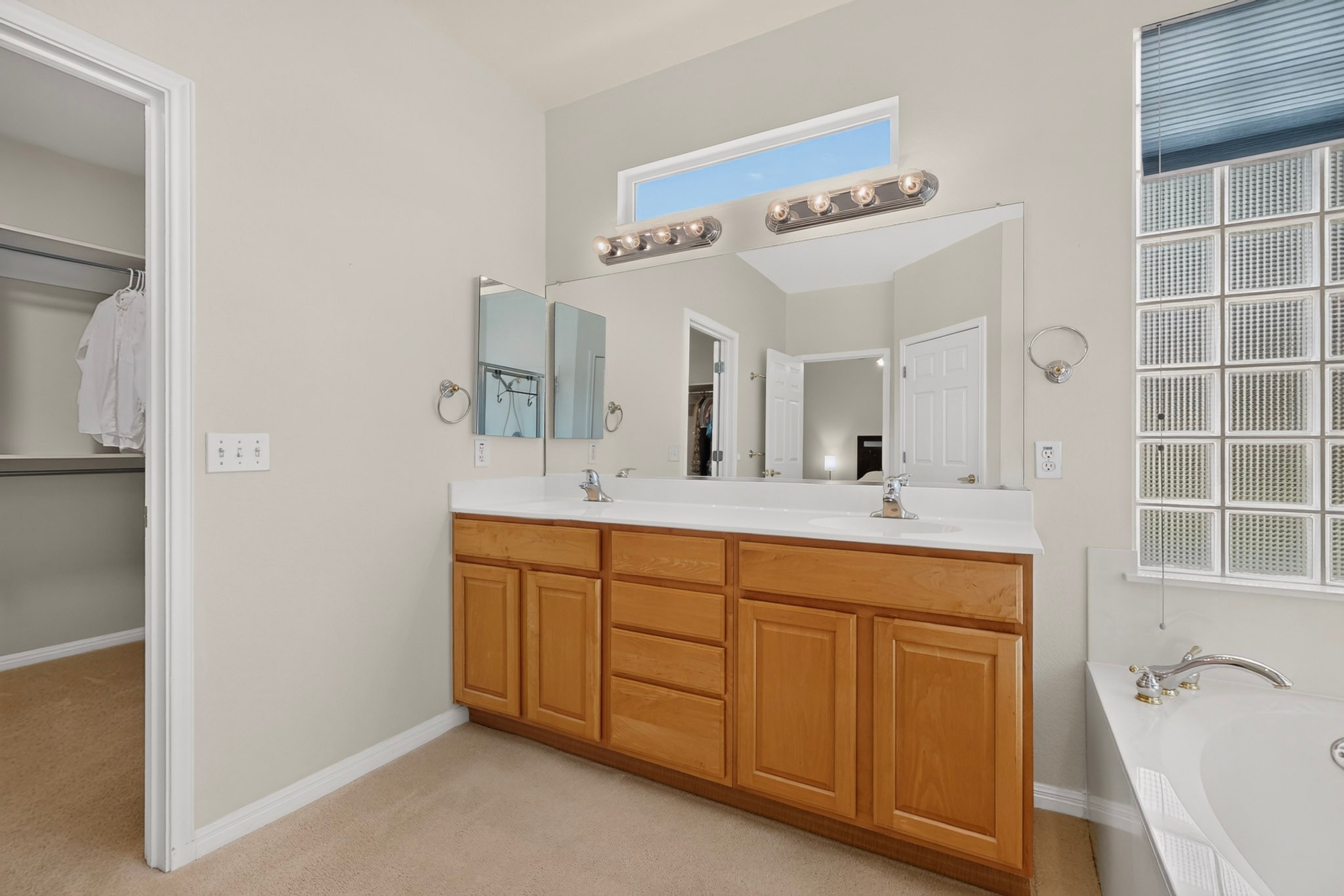 207 Red Poppy Trail Georgetown, TX 78633 - Photo 18 of 31 Double vanity with ample storage and a large mirror defines this functional primary bathroom.
