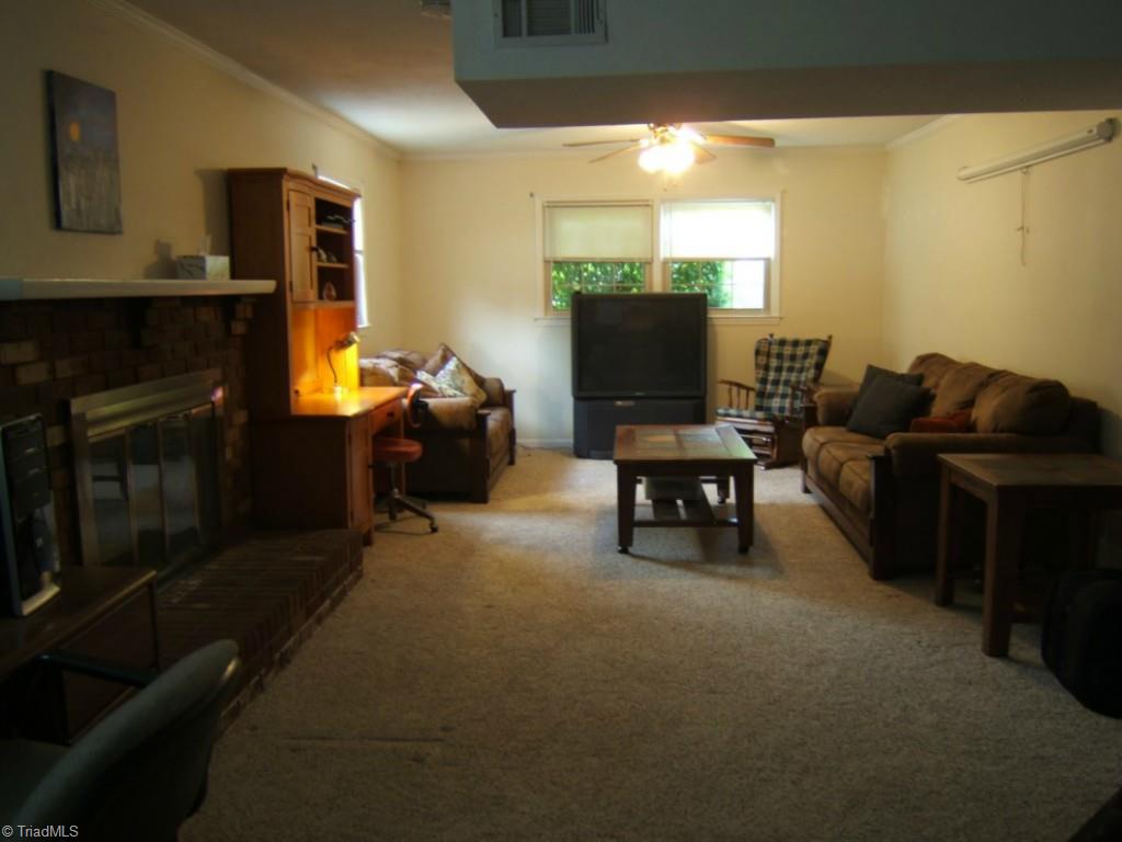 2991 Hickory Tree Road Winston-Salem, NC 27127 - Photo 13 of 26 Lower level Den/Living room. Office space at other end has entry door from carport.