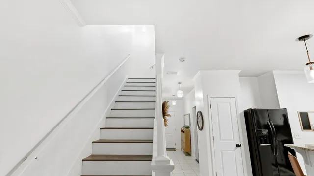 a view of a hallway with wooden floor and staircase
