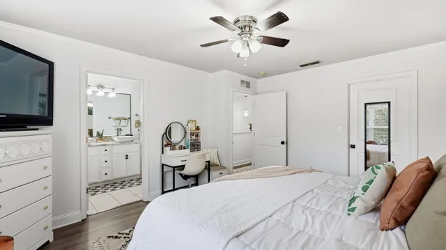 a large white bathroom with a granite countertop sink and a mirror