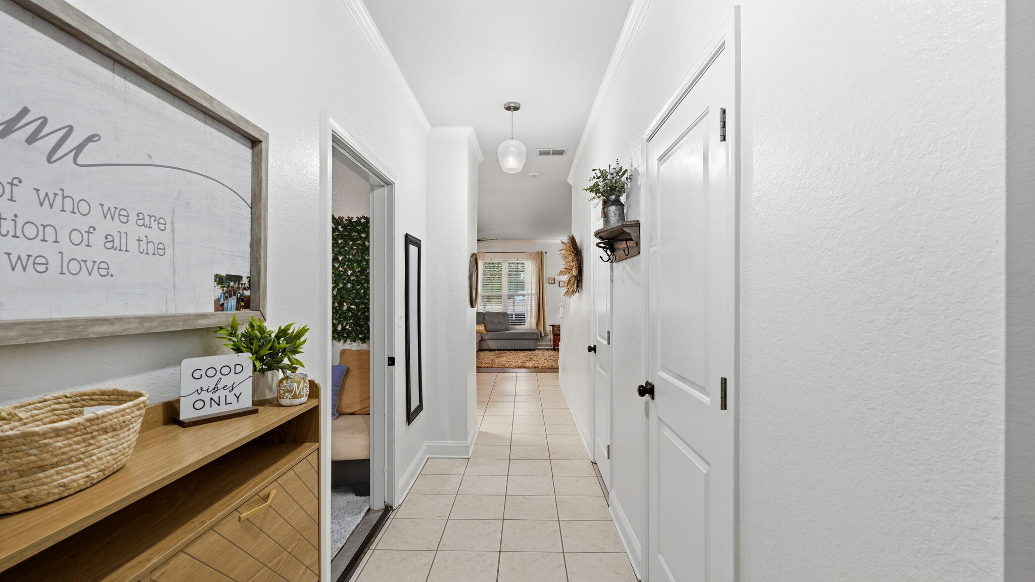 22 North Sand Palm Road, Unit 15 Freeport, FL 32439 - Photo 4 of 40 a hallway with dining area and chandelier