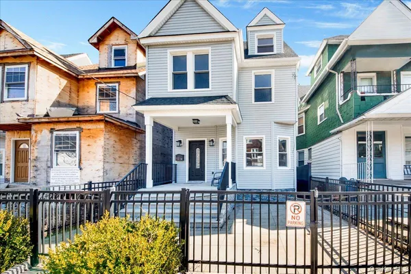 a front view of a house with a garden