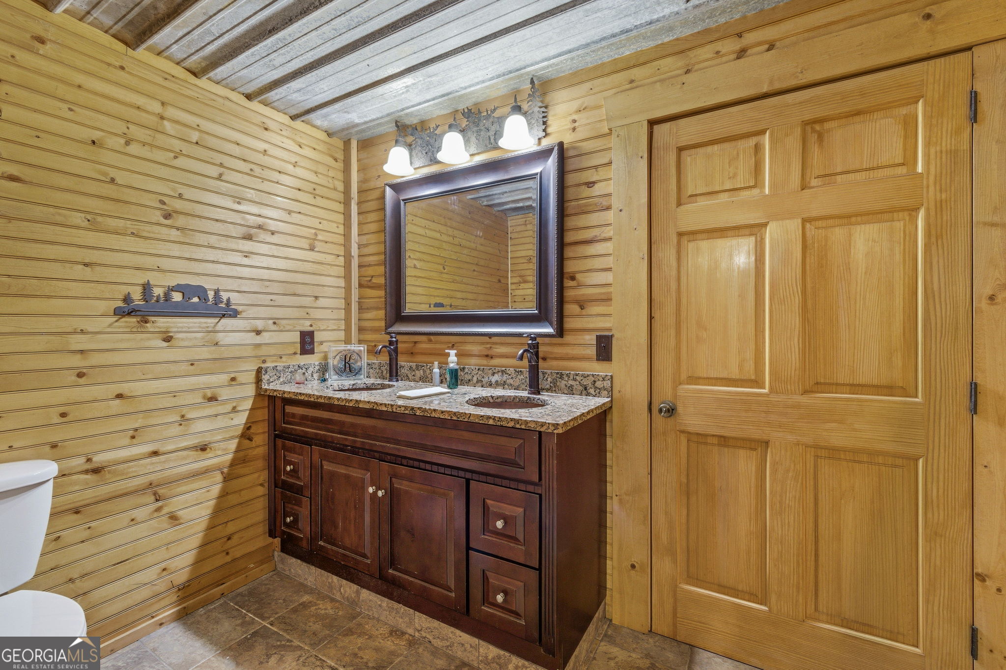 401 Herrin Road Cornelia, GA 30531 - Photo 63 of 83 a bathroom with a granite countertop toilet sink and mirror