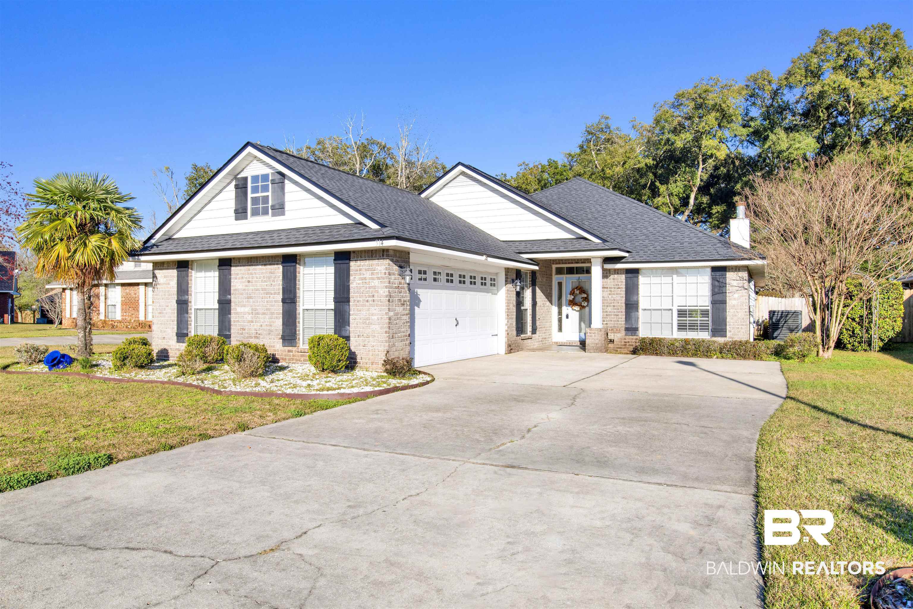 314 Blackfriars Street Fairhope, AL 36532 - Photo 1 of 25 View of front of property with a front lawn, concrete driveway, brick siding, and an attached garage