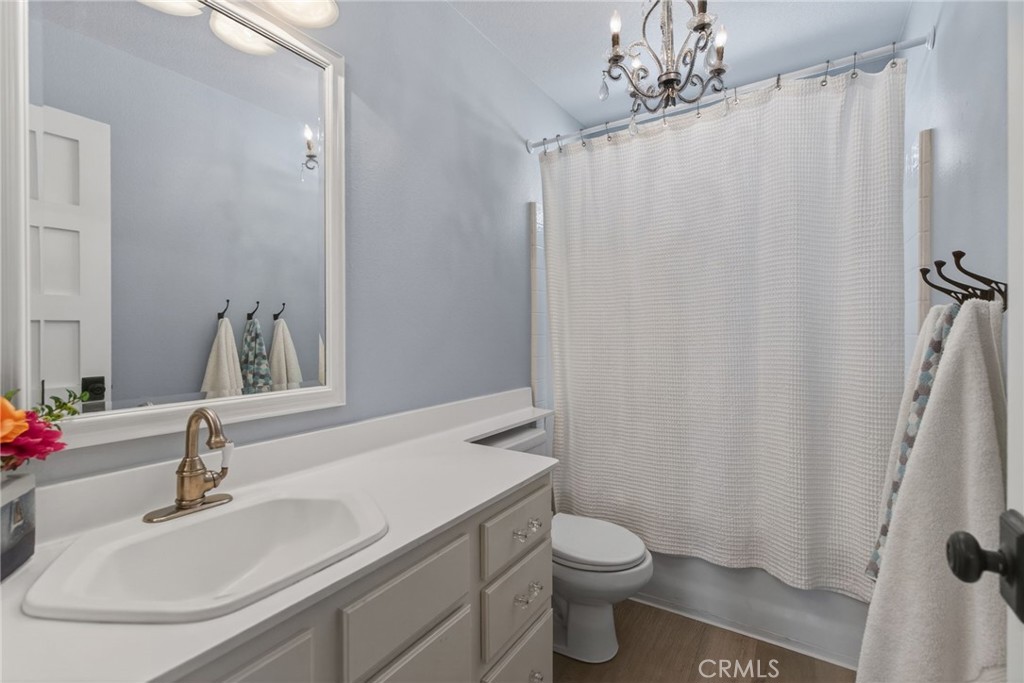 19584 Jill Court Riverside, CA 92508 - Photo 18 of 31 a bathroom with a granite countertop sink toilet and a mirror