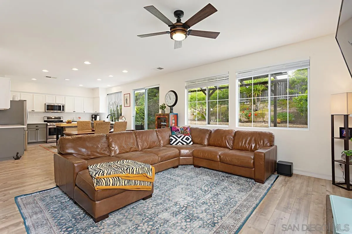 1058 Bells Drive Oceanside, CA 92057 - Photo 11 of 31 a living room with furniture ceiling fan and a rug