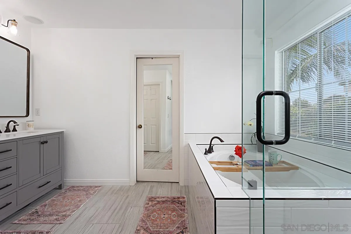 1058 Bells Drive Oceanside, CA 92057 - Photo 19 of 31 a bathroom with a sink and mirror