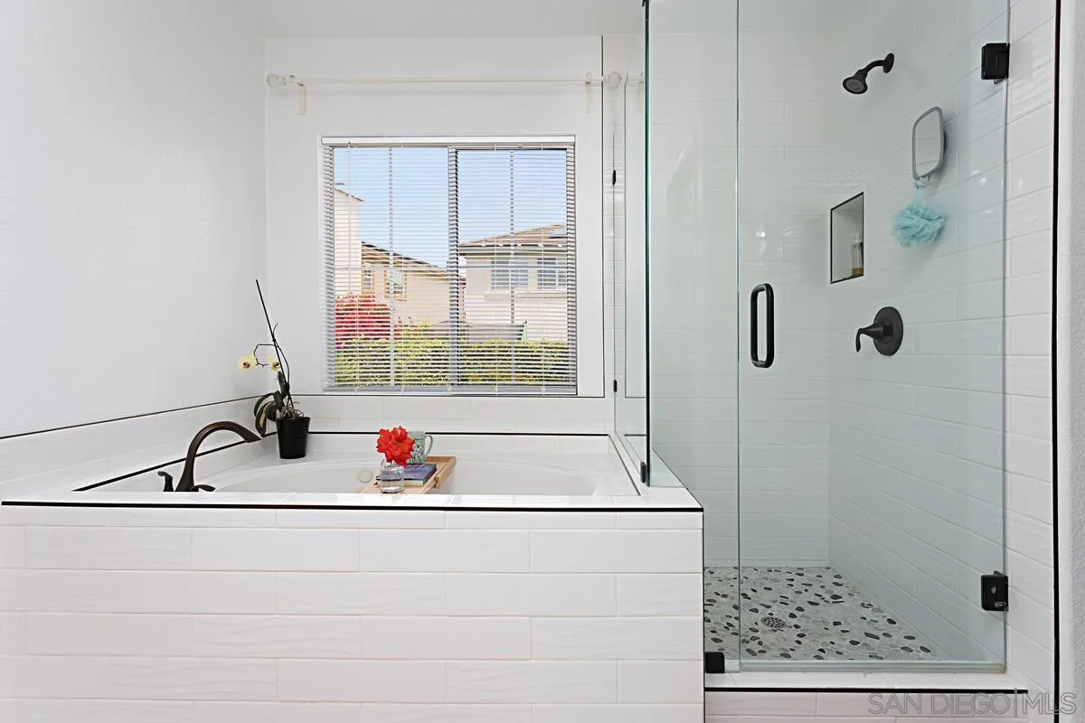 1058 Bells Drive Oceanside, CA 92057 - Photo 21 of 31 a bathroom with a granite countertop sink a mirror and shower