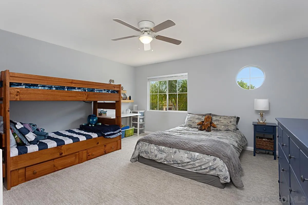 1058 Bells Drive Oceanside, CA 92057 - Photo 22 of 31 a bedroom with a bed and a ceiling fan