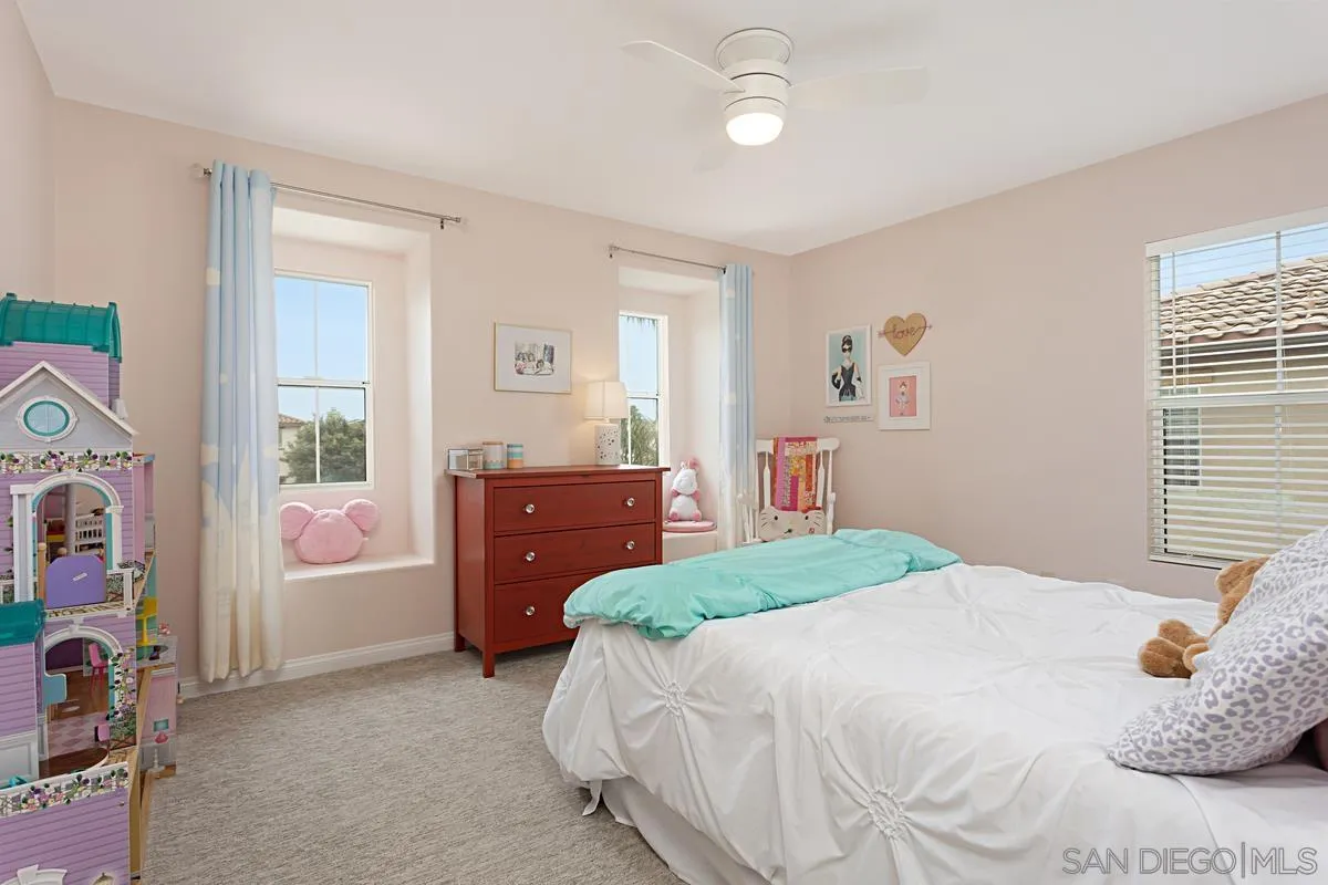 1058 Bells Drive Oceanside, CA 92057 - Photo 24 of 31 a bedroom with a bed and a cabinets