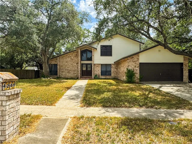 a house that has a tree in front of it