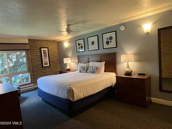 a bedroom with a large bed and a large window