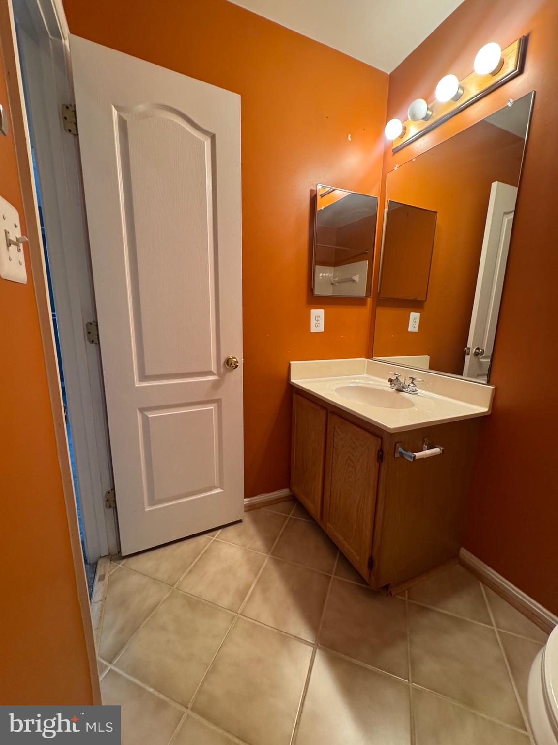 7705 Periwinkle Way, Unit 71 Severn, MD 21144 - Photo 22 of 28 a bathroom with a sink toilet and mirror
