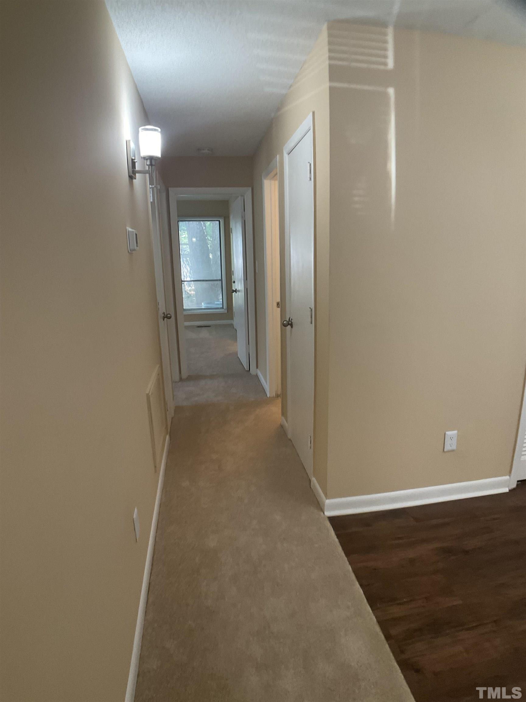 5812 Pointer Drive, Unit 101 Raleigh, NC 27609 - Photo 18 of 30 a view of a hallway with wooden floor