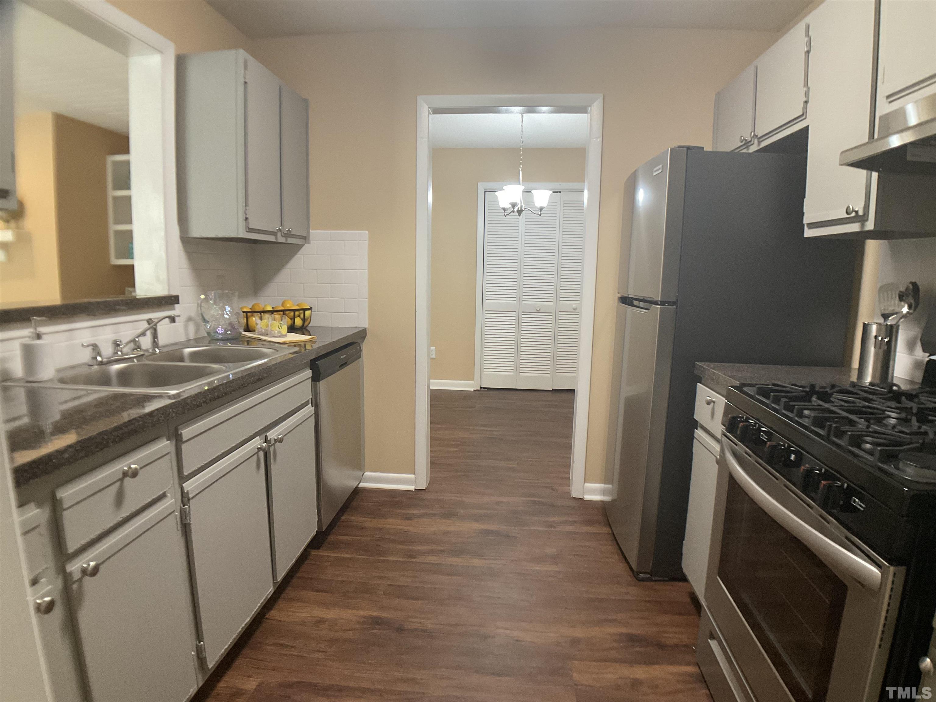 5812 Pointer Drive, Unit 101 Raleigh, NC 27609 - Photo 3 of 30 a kitchen with a sink stove and refrigerator